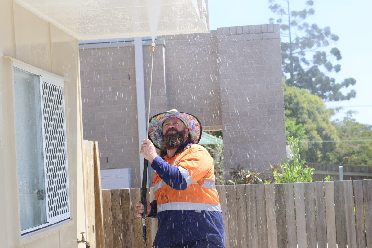 Fresh Again technician performing professional pressure washing on a Zillmere property exterior
