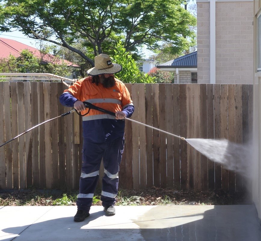 Fresh Again owner pressure washing a residential wall in Brisbane