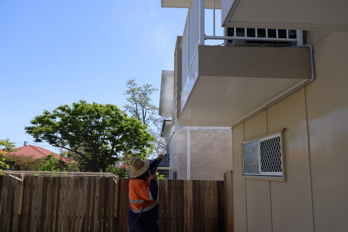 Fresh Again technician pressure washing the bottom area of a home balcony in Everton Park.