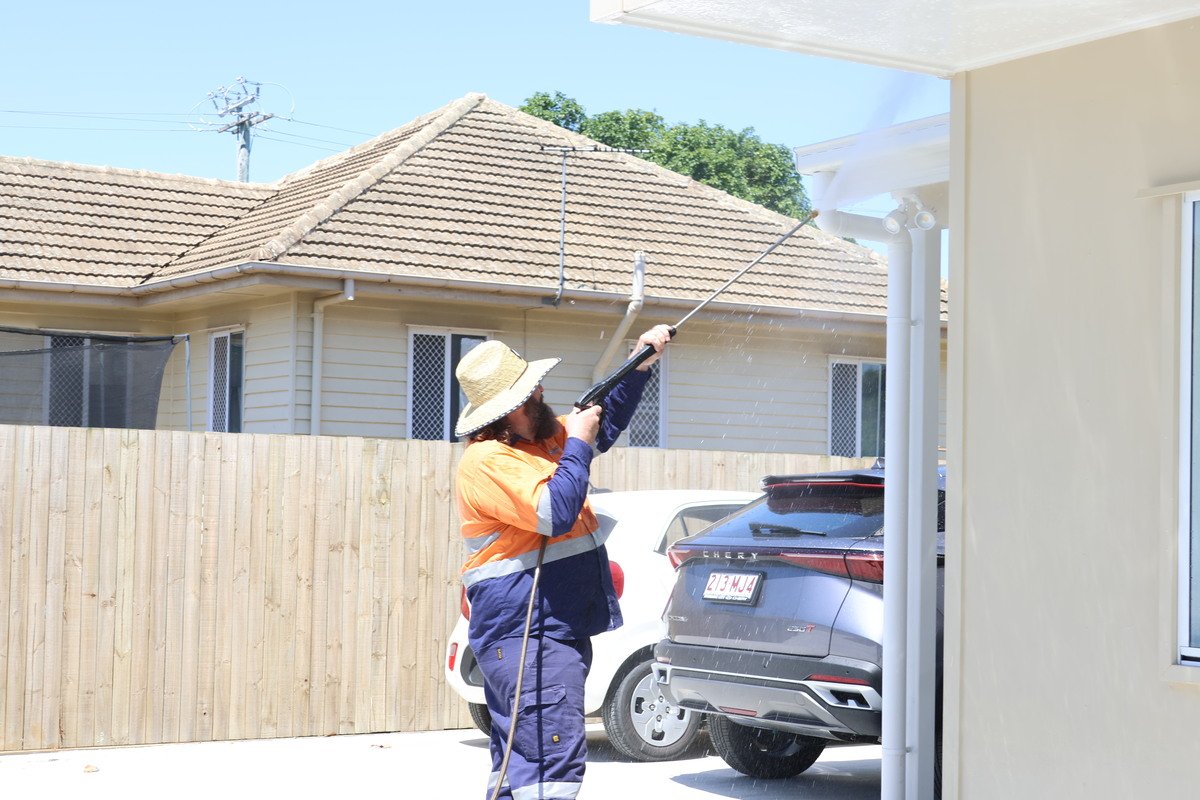 Professional pressure washing of house gutters in Stafford for effective dirt and debris removal