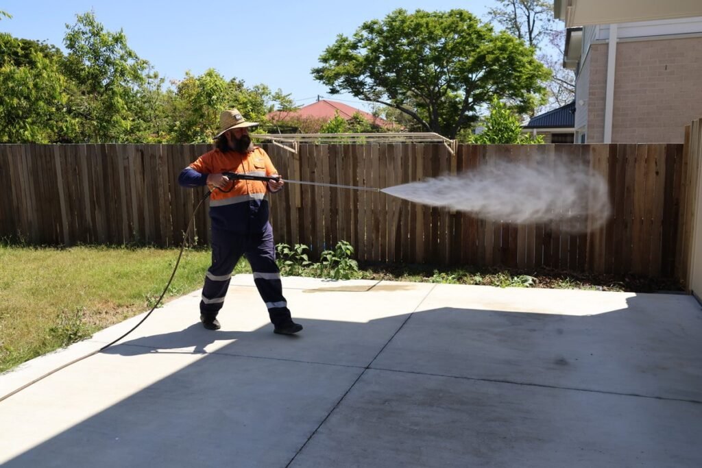 Pressure washing expert in Brisbane preparing to clean house exterior