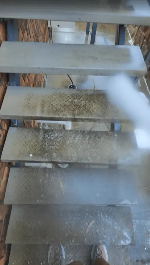 FRSH Again removing mould and built-up grime from outdoor metal stairs in Brisbane.