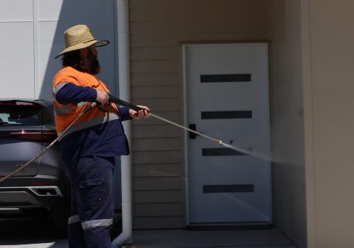Fresh Again Owner pressure washing the exterior of a home in Brisbane during a professional house washing service