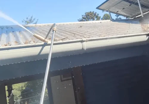 Professional gutter cleaning in progress on a Brisbane home